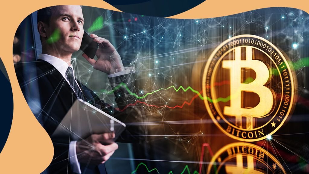 Man holding a phone and laptop on the background of Bitcoin and crypto graph.